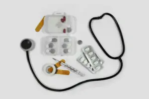 Medical essentials including stethoscope, pill organizer, medication, and first aid supplies